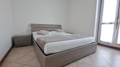 a bedroom with a large bed with a wooden headboard at JENNAH House in Bussero