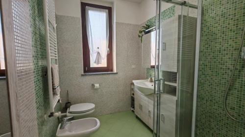 a bathroom with a sink and a toilet and a shower at JENNAH House in Bussero