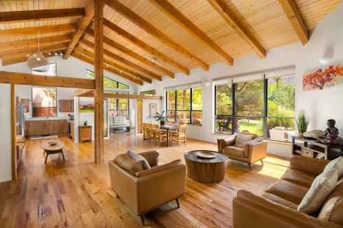 a living room with couches and a dining room at Nama-Stay Retreat Village in Springdale