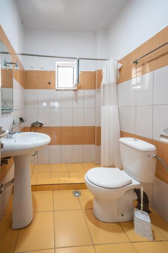 a bathroom with a toilet and a sink at Horizon Villa Ksamil in Ksamil