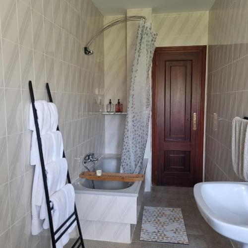 a bathroom with a tub and a sink and a shower at Dorna Vella in Valdoviño