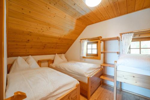 a bedroom with two beds in a wooden cabin at my Hütten Katschberg in Katschberghöhe
