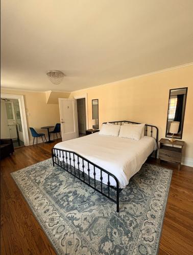a bedroom with a large bed with a rug at The Ambassador in Ottawa