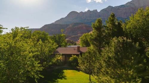 a house with a mountain in the background at Nama-Stay Retreat Village in Springdale