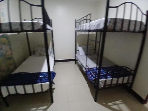 a room with two bunk beds in a room at Friendly hostel in Arusha