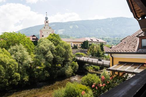 a view of a town with a bridge and a church at Hotel Restaurant Platzer in Gmünd in Kärnten