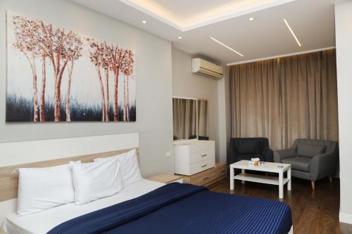 a bedroom with a bed and a living room with a couch at Munir`s residence 2 in Cairo