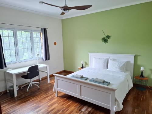 a bedroom with a white bed and a desk at LAVA Açores Coliving in Ribeira Grande