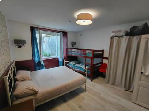 a small bedroom with a bed and a window at Le nid douillet Vintage idéal pour 2 jusqu'à 4 in La Bourboule