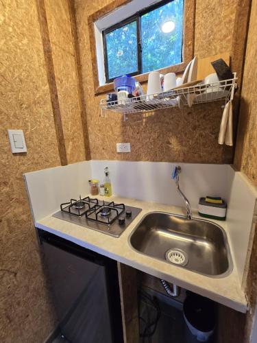a kitchen with a sink and a counter top at EcoHotel Farallones in San Pedro de Jagua