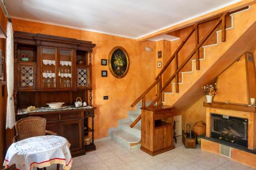 a living room with a staircase and a fireplace at Villetta Dina in Scoffera