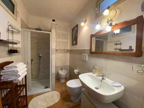 a bathroom with a sink and a toilet and a shower at Anna Rita Alghero B&B in Fertilia