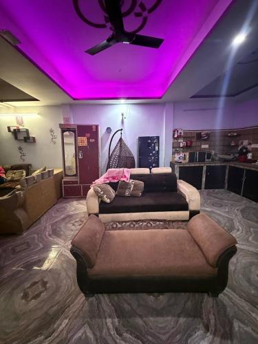a room with two beds and a purple ceiling at Dixit's Villa! in Kānpur
