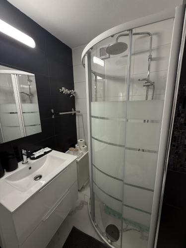 a bathroom with a glass shower and a sink at Sun & Sea in Sounio