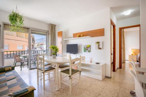 a living room with a table and chairs and a television at Home2Book Sunny Terrace Apt, el Rincón de ManFe in Candelaria