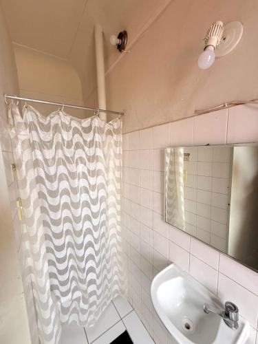 a bathroom with a sink and a shower curtain at Hotel Central in Recife