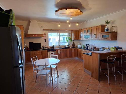 a kitchen with a table and chairs in it at LAVA Açores Coliving in Ribeira Grande