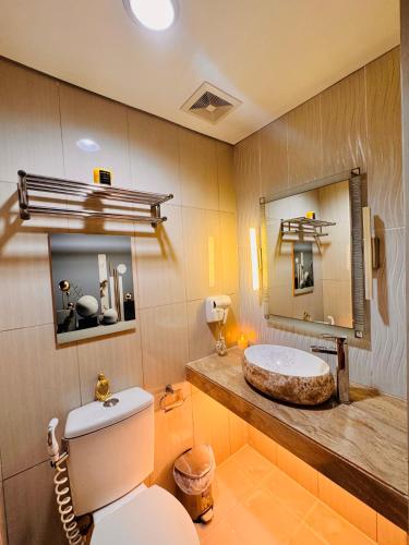 a bathroom with a white toilet and a sink at Shell Residences Tower A B in Manila