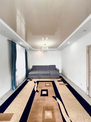 a bedroom with a bed and a chandelier at Sun House in Cholpon-Ata