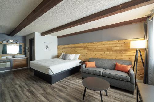 a hotel room with a bed and a couch at Trailhead Lodge in Bend