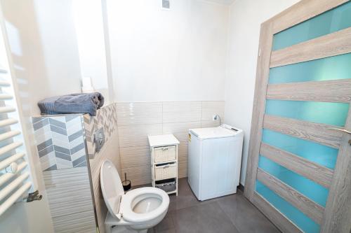 a small bathroom with a toilet and a sink at Central Apartments Premium in Goleniów