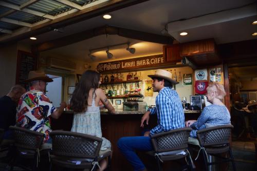 a group of people sitting at a bar at The Equus in Honolulu