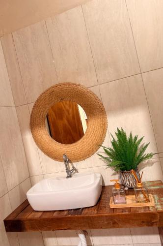 a bathroom with a sink and a mirror on a counter at Rancho PJ - Presidente Juscelino-MA in Morros