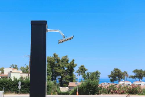 a street light with a street sign on it at The Serata Villas in Hanioti