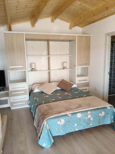 a bedroom with a large bed in a room at Apartamentos Playa Frejulfe in Paderne
