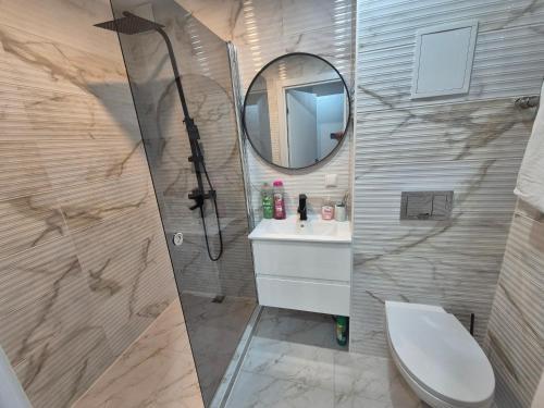 a bathroom with a shower and a sink and a mirror at Like home in Narva