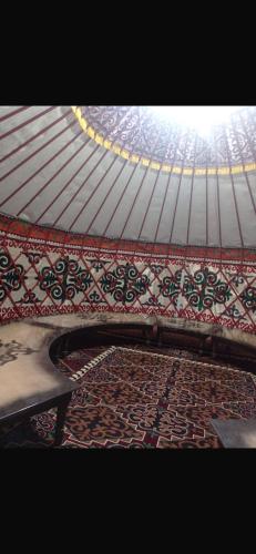 a roof with a bench and a rug under it at Saida guest house in Rybpunkt
