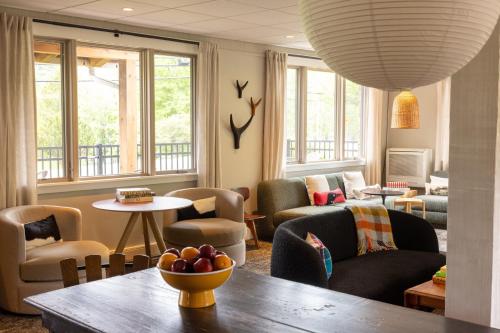 a living room with a table and chairs and windows at The Outpost by Windham Mountain Club in Windham