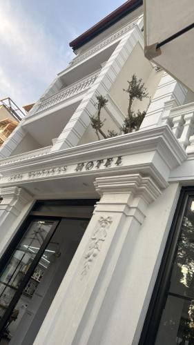 a white building with plants on the side of it at Hotel sefa brothers in Golem