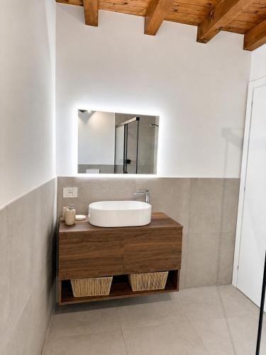 a bathroom with a sink and a mirror at B&B Casa Olivia in Gardone Riviera