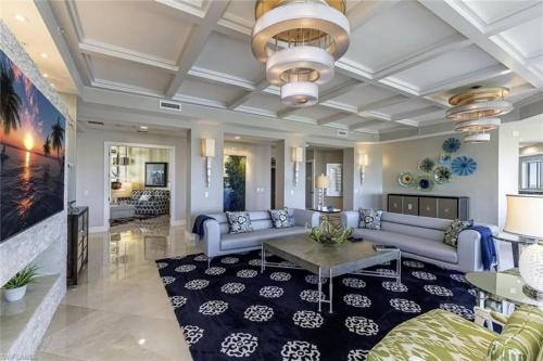 a living room with a couch and a table at Grande Vista Retreat in Naples