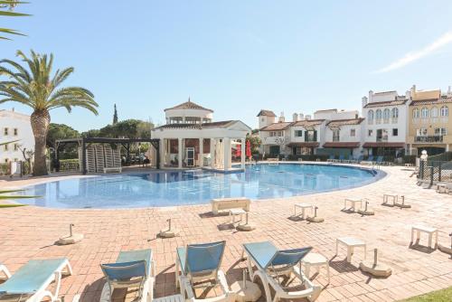 a swimming pool with lounge chairs and a resort at Old Village & Prestige in Vilamoura