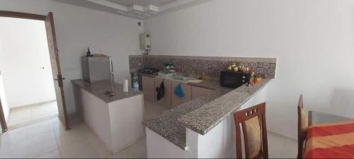 a kitchen with a counter top in a room at Maison front de mer 2 in Kelibia
