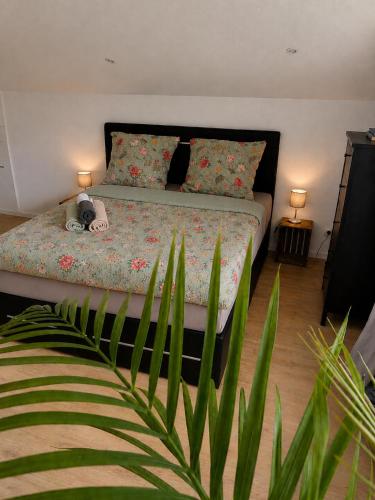a bedroom with a bed with a plant at Haus Johannes in Braubach