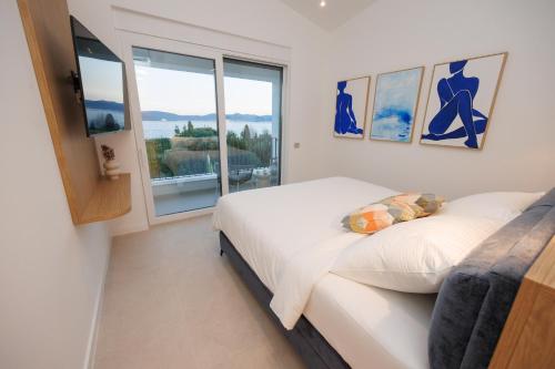 a bedroom with a bed and a large window at Villa Marcello in Zadar