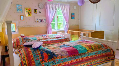 a bedroom with two beds and a window at Lindgren Land in Vimmerby