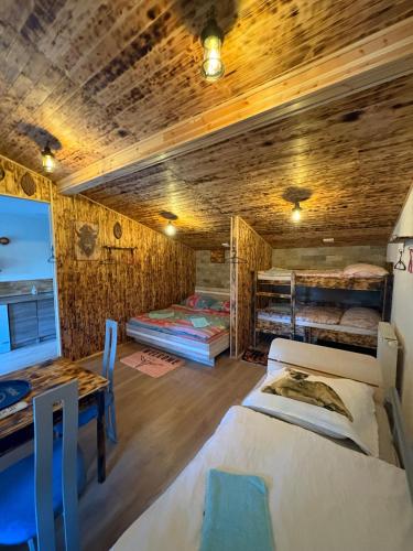 a room with two beds and a table with a desk at Kempink U Šerifa in Protivín
