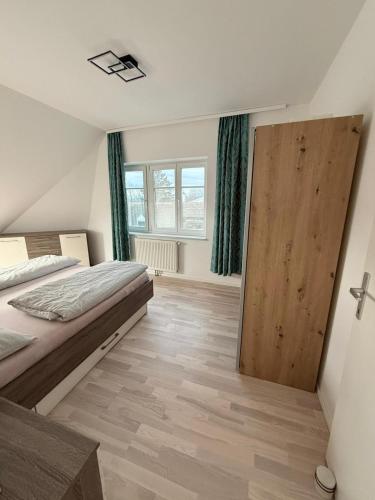 a bedroom with a bed and a sliding door at Chill & Enjoy in Leopoldsdorf
