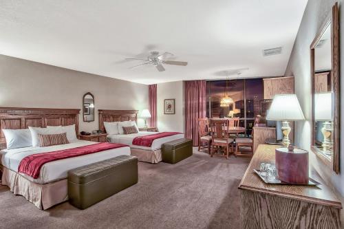 a hotel room with two beds and a living room at Plaza Resort Club Reno in Reno