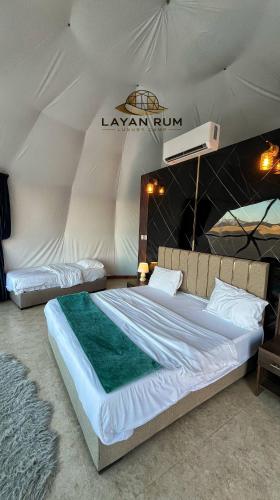 a bedroom with two beds in a tent at LAYAN RUM LUXURY CAMP & Jeep Tours in Wadi Rum