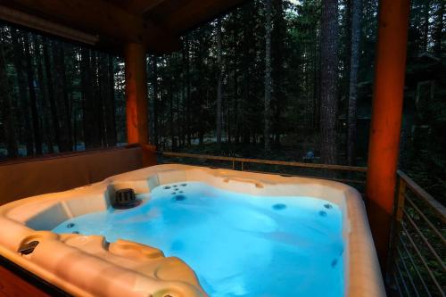 a hot tub on the porch of a cabin at Elysian at Mount Baker in Glacier