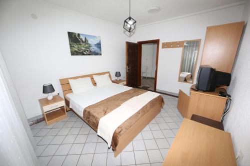 a bedroom with a bed and a tv in it at Villa Kaya in Ohrid