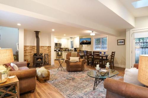 a living room with a couch and a table and a kitchen at Kulshan Cabin in Glacier
