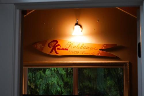 a surfboard on top of a window with a light at Kulshan Cabin in Glacier