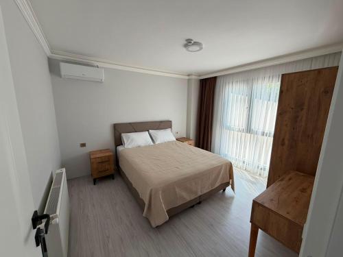 a hotel room with a bed and a window at Atlas Suite Trabzon in Trabzon