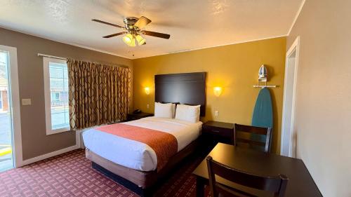 a hotel room with a large bed and a table at Capitol Hill Motel in Portland